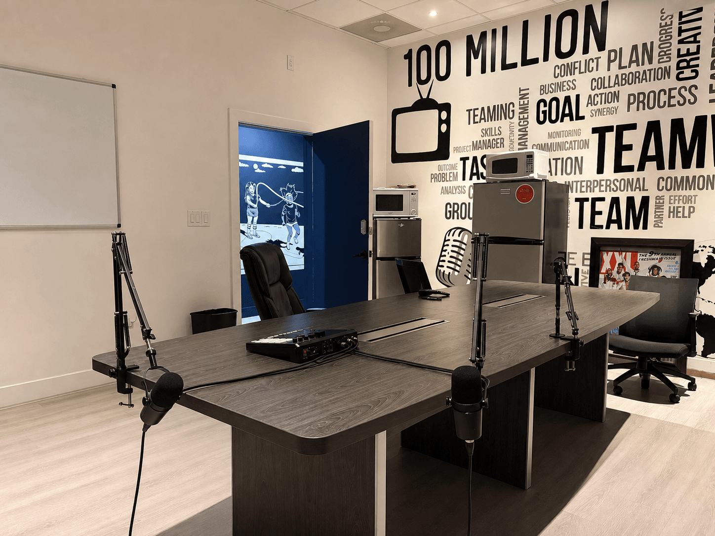 Podcast Room with a large production table and boom-mounted microphones